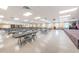 Spacious hall with tables, chairs, and a small stage area for various events at 196 Philadelphia Blvd # 10, Palm Harbor, FL 34684