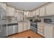 Well-lit kitchen with stainless steel appliances and wood-look flooring at 196 Philadelphia Blvd # 10, Palm Harbor, FL 34684