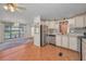 Open kitchen with stainless steel appliances and adjacent dining and living areas at 196 Philadelphia Blvd # 10, Palm Harbor, FL 34684