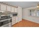 Compact kitchen with stainless steel appliances and wood-look flooring at 196 Philadelphia Blvd # 10, Palm Harbor, FL 34684