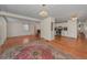 Bright living room with wood-look floors, large windows open to the kitchen at 196 Philadelphia Blvd # 10, Palm Harbor, FL 34684