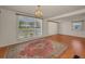 Bright living room with wood-look floors, large windows and elegant chandelier at 196 Philadelphia Blvd # 10, Palm Harbor, FL 34684