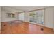 Bright living room with wood-look floors, large windows and elegant chandelier at 196 Philadelphia Blvd # 10, Palm Harbor, FL 34684