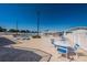 Community pool deck with table, chairs, and umbrellas at 196 Philadelphia Blvd # 10, Palm Harbor, FL 34684