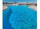 Large outdoor pool with crystal blue water and surrounding lounge area perfect for relaxation and recreation at 196 Philadelphia Blvd # 10, Palm Harbor, FL 34684