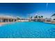 Community pool surrounded by lounge chairs, offering a refreshing escape for residents to unwind at 196 Philadelphia Blvd # 10, Palm Harbor, FL 34684