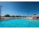 Community pool surrounded by lounge chairs, offering a refreshing escape for residents to unwind at 196 Philadelphia Blvd # 10, Palm Harbor, FL 34684