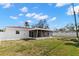 Grassy backyard featuring a screened patio, white privacy fence, and well-kept landscaping at 1974 Valencia Way, Clearwater, FL 33764