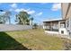 Manicured backyard with a well-maintained lawn and a screened patio at 1974 Valencia Way, Clearwater, FL 33764