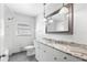 Bathroom features marble countertop vanity, framed mirror and shower-tub combo at 1974 Valencia Way, Clearwater, FL 33764