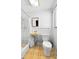 Modest bathroom with shower, linoleum floors and original fixtures at 1974 Valencia Way, Clearwater, FL 33764