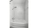 Clean and modern bathroom featuring tub and shower with white marble tile at 1974 Valencia Way, Clearwater, FL 33764