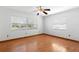 Bare bedroom featuring hardwood flooring, neutral walls, and natural light through windows at 1974 Valencia Way, Clearwater, FL 33764