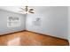 A well-lit bedroom with hardwood floors and two windows at 1974 Valencia Way, Clearwater, FL 33764
