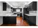Stylish kitchen featuring black cabinets, white countertops, terracotta tile flooring, and stainless steel appliances at 1974 Valencia Way, Clearwater, FL 33764