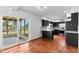 Modern kitchen with sleek black cabinetry, stainless steel appliances, and access to a bright outdoor patio at 1974 Valencia Way, Clearwater, FL 33764