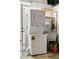 Laundry space with stacked washer/dryer and utility sink at 1974 Valencia Way, Clearwater, FL 33764