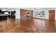 Inviting living room with beautiful terracotta tile flooring, a charming brick fireplace, and an open doorway to kitchen at 1974 Valencia Way, Clearwater, FL 33764