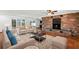 Elegant living room with a cozy brick fireplace, plush seating, and sliding glass doors with lots of light at 1974 Valencia Way, Clearwater, FL 33764