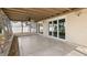 Covered patio with concrete flooring and large sliding glass doors leading to the exterior at 1974 Valencia Way, Clearwater, FL 33764