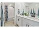 Bathroom featuring double sinks, white cabinets, and a shower/tub combo at 22287 Blazing Star Run, Land O Lakes, FL 34637