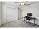 Bedroom with desk and chair setup, ceiling fan, and double door closet at 22287 Blazing Star Run, Land O Lakes, FL 34637