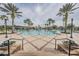 Resort-style pool area surrounded by lush landscaping and palm trees at 22287 Blazing Star Run, Land O Lakes, FL 34637