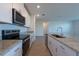 Spacious kitchen featuring granite countertops, stainless steel appliances, and a large kitchen island at 31647 Malbec Dr, Brooksville, FL 34602