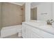 Bright bathroom featuring white vanity, shower over tub, and modern fixtures at 31869 Anchor Point Dr, Wesley Chapel, FL 33545