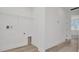 Functional laundry room with modern flooring, shelving, and convenient access at 31869 Anchor Point Dr, Wesley Chapel, FL 33545