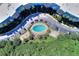 Overhead aerial showcases building's unique shape, central pool, well-maintained landscaping, and ample parking at 3315 58Th S Ave # 314, St Petersburg, FL 33712