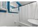 Compact blue and white bathroom with a shower-tub and mirrored vanity at 3315 58Th S Ave # 314, St Petersburg, FL 33712