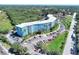 View of the blue condo with ample parking and mature landscaping surrounding the building in a well-maintained community at 3315 58Th S Ave # 314, St Petersburg, FL 33712