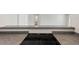 Close up of a black glass cooktop against a sleek countertop with a view into the bathroom at 3315 58Th S Ave # 314, St Petersburg, FL 33712