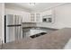Well-equipped kitchen with stainless steel appliances, breakfast bar, and white cabinets at 3315 58Th S Ave # 314, St Petersburg, FL 33712