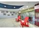 Bright condo lobby with modern decor, red chairs, decorative wall and photograph gallery at 3315 58Th S Ave # 314, St Petersburg, FL 33712