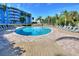 Large circular pool surrounded by lounge chairs and tropical landscaping at 3315 58Th S Ave # 314, St Petersburg, FL 33712