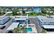 Aerial view of building highlighting in-ground pool, parking, canal access, and neighborhood at 4400 37Th S St # 2, St Petersburg, FL 33711