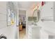 Elegant bathroom with shiplap walls, a marble vanity, and a stylish mirror, creating a serene atmosphere at 4400 37Th S St # 2, St Petersburg, FL 33711