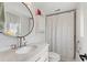 Modern bathroom featuring shiplap walls, a marble vanity, and a shower with a stylish curtain, creating a serene atmosphere at 4400 37Th S St # 2, St Petersburg, FL 33711