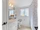 Bright bathroom features shiplap walls, elegant vanity with marble countertop, and a window with decorative curtains at 4400 37Th S St # 2, St Petersburg, FL 33711