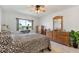Bright bedroom with a large window, wood furniture, and a comfortable bed, creating a serene and welcoming space at 4400 37Th S St # 2, St Petersburg, FL 33711