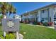 Well-maintained condo complex with lush landscaping and a welcoming entrance sign at 4400 37Th S St # 2, St Petersburg, FL 33711