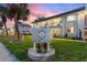 Maximo Harbour Condominiums building featuring well-manicured landscaping and prominent signage at sunset at 4400 37Th S St # 2, St Petersburg, FL 33711