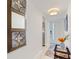 Bright hallway with elegant decor, travertine flooring, and a decorative mirror at 4400 37Th S St # 2, St Petersburg, FL 33711
