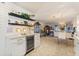 Cozy bar area in kitchen with wine cooler, decor shelving, and view of living spaces at 4400 37Th S St # 2, St Petersburg, FL 33711