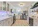 Well-lit modern kitchen with stainless steel appliances, white cabinets, and quartz countertops at 4400 37Th S St # 2, St Petersburg, FL 33711