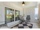 Relaxing screened lanai with stone walls, neutral tile flooring, and comfortable seating at 4400 37Th S St # 2, St Petersburg, FL 33711