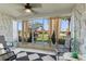 Relaxing screened lanai with stone walls, neutral tile flooring, and comfortable seating at 4400 37Th S St # 2, St Petersburg, FL 33711