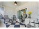 Relaxing screened lanai with stone walls, neutral tile flooring, and comfortable seating at 4400 37Th S St # 2, St Petersburg, FL 33711